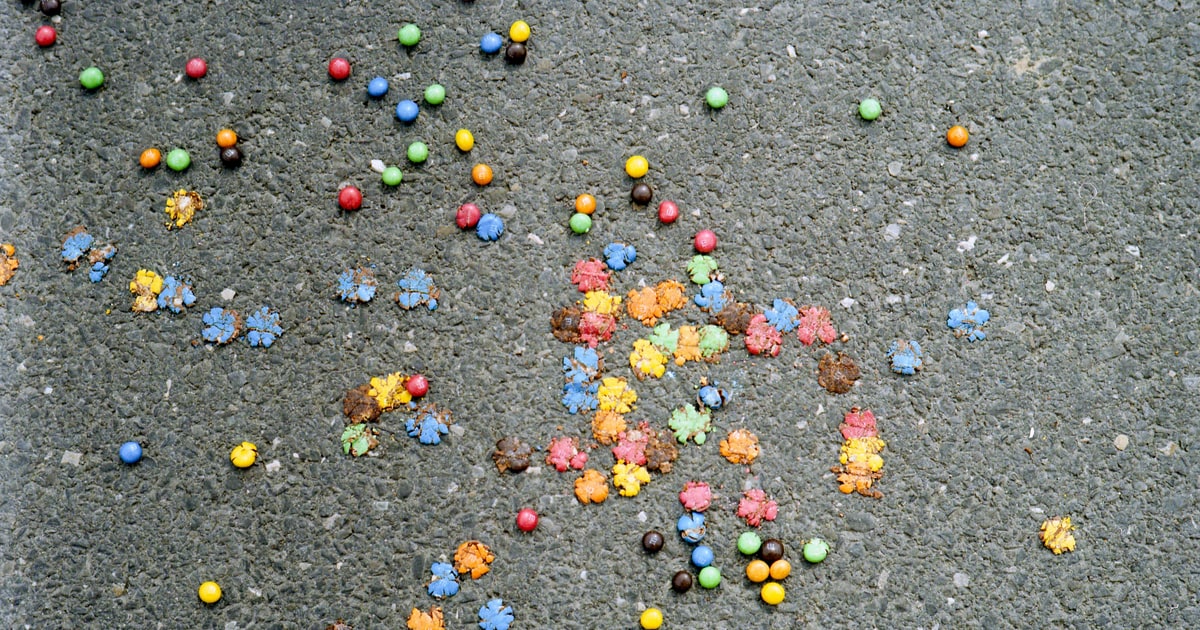 Colourful M&Ms chocolate sweets spilling from a bag