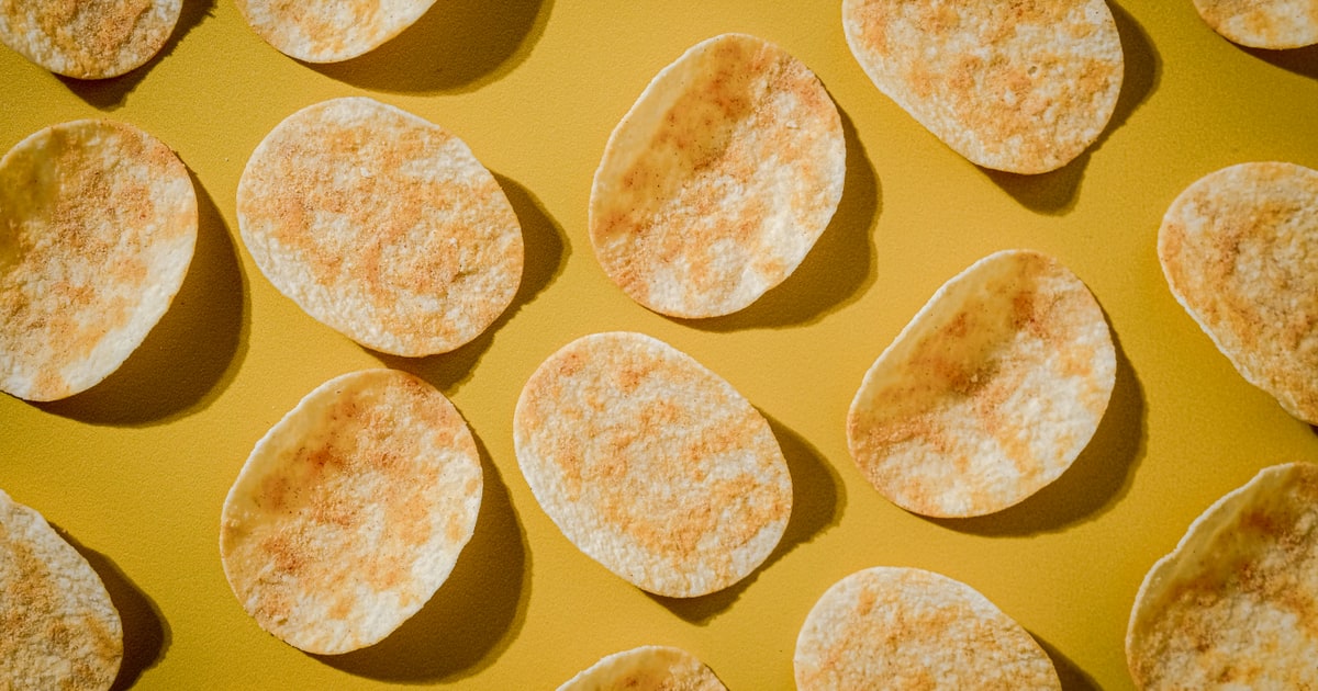 Stack of Pringles crisps tubes showing ingredient labels