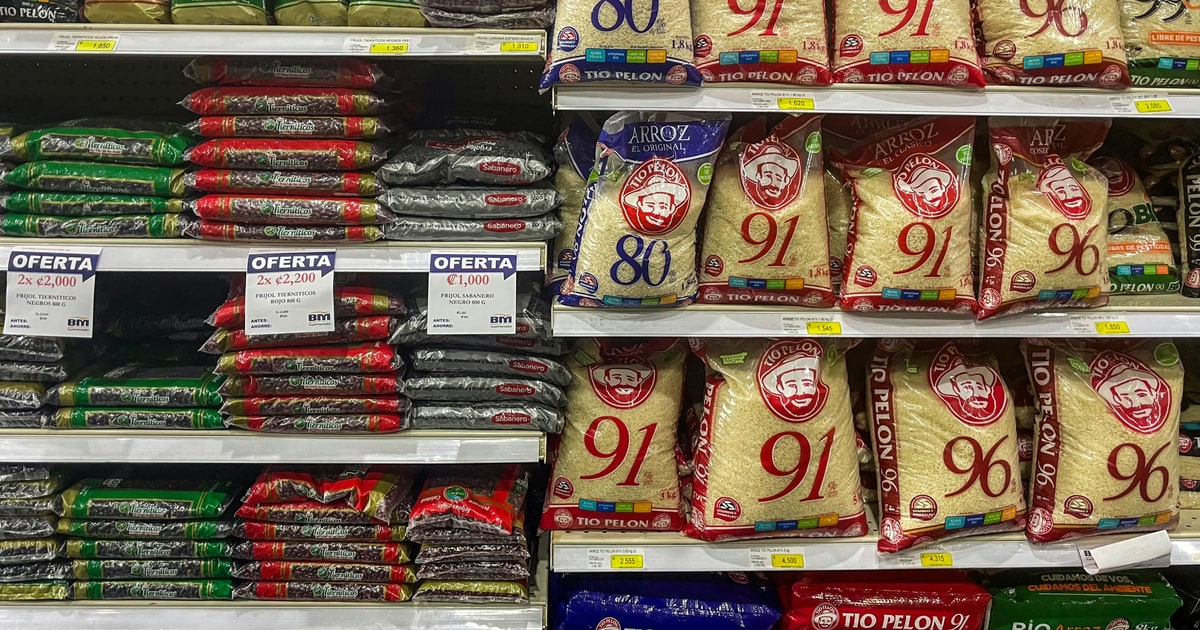 Consumer checking halal and boycott status of food brands at a supermarket shelf