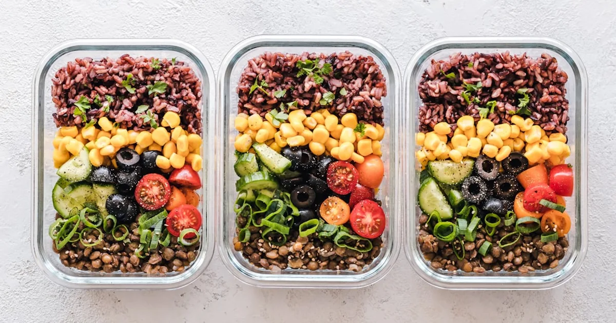 Prepared halal meal prep boxes with chicken, rice, and vegetables in containers