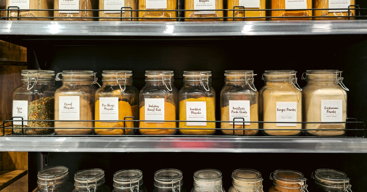 Spice jars lined up in a grocery store — E-codes appear in the ingredients of everyday foods like these