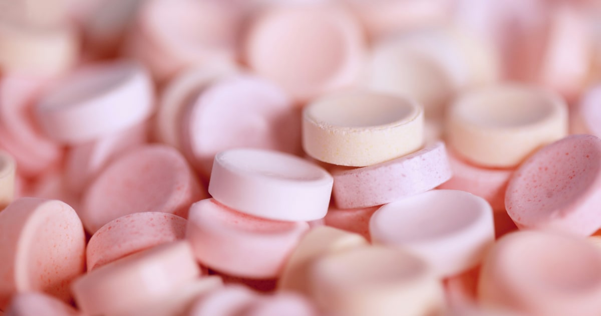 Sugar-free chewing gum and sweets containing E420 sorbitol on a white background