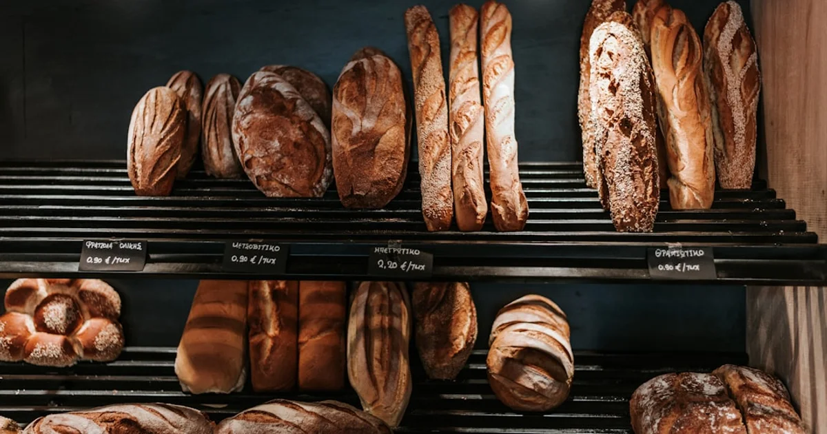 Sliced bread loaves and iced cakes on a South African supermarket bakery counter