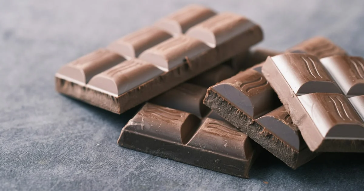Assorted chocolate bars and wafers on a market stall counter