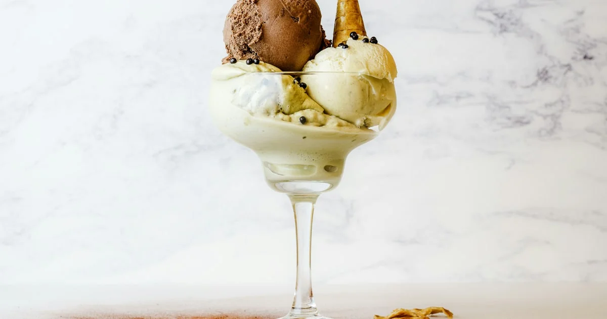 Ice cream cones and tubs on a pale background