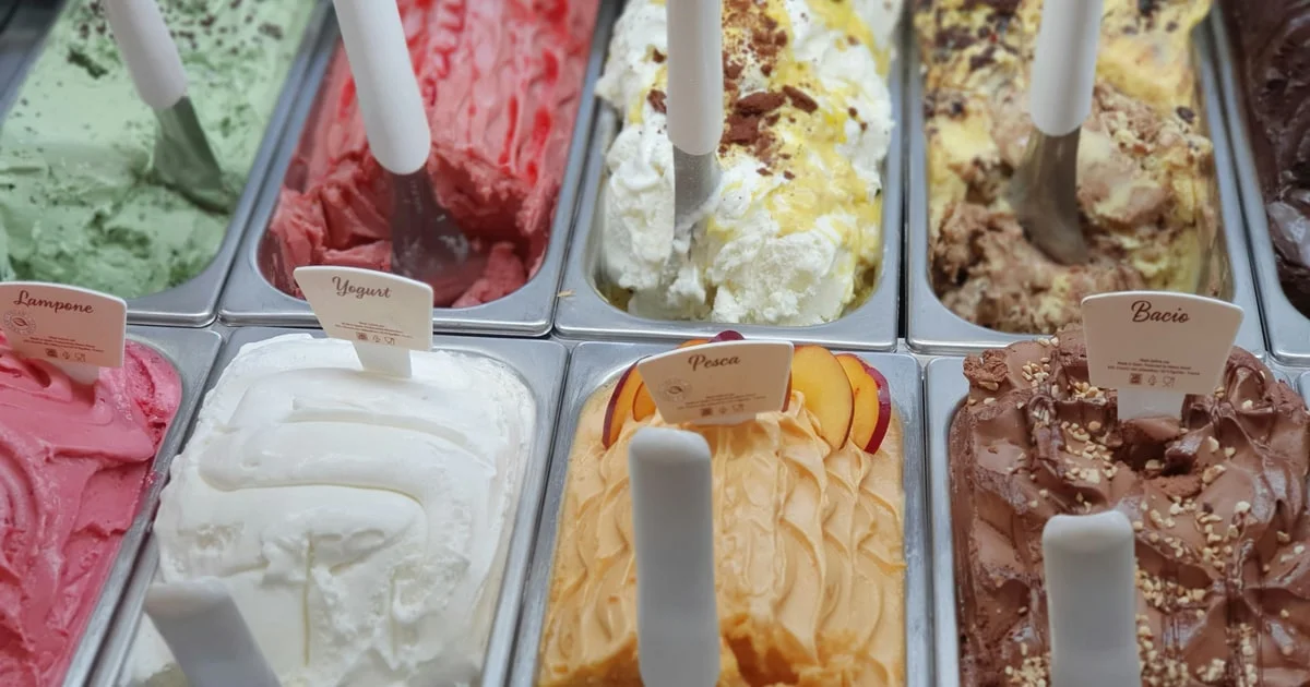 Ice cream tubs and cones in a freezer cabinet