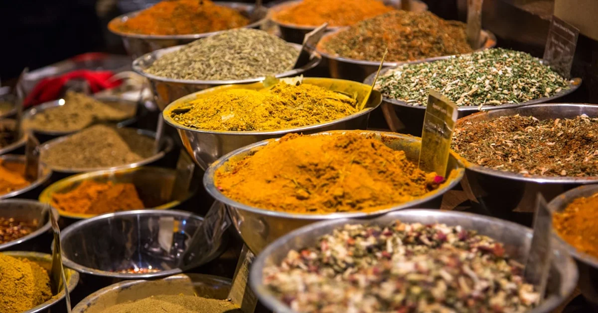 Bowls of colourful spices at a Middle Eastern grocery market counter