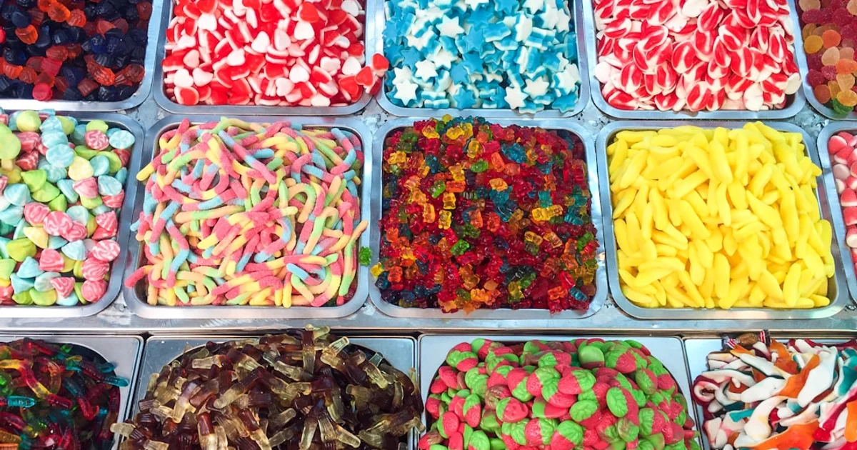 Colourful assorted gummy sweets and candy in a pick and mix bowl