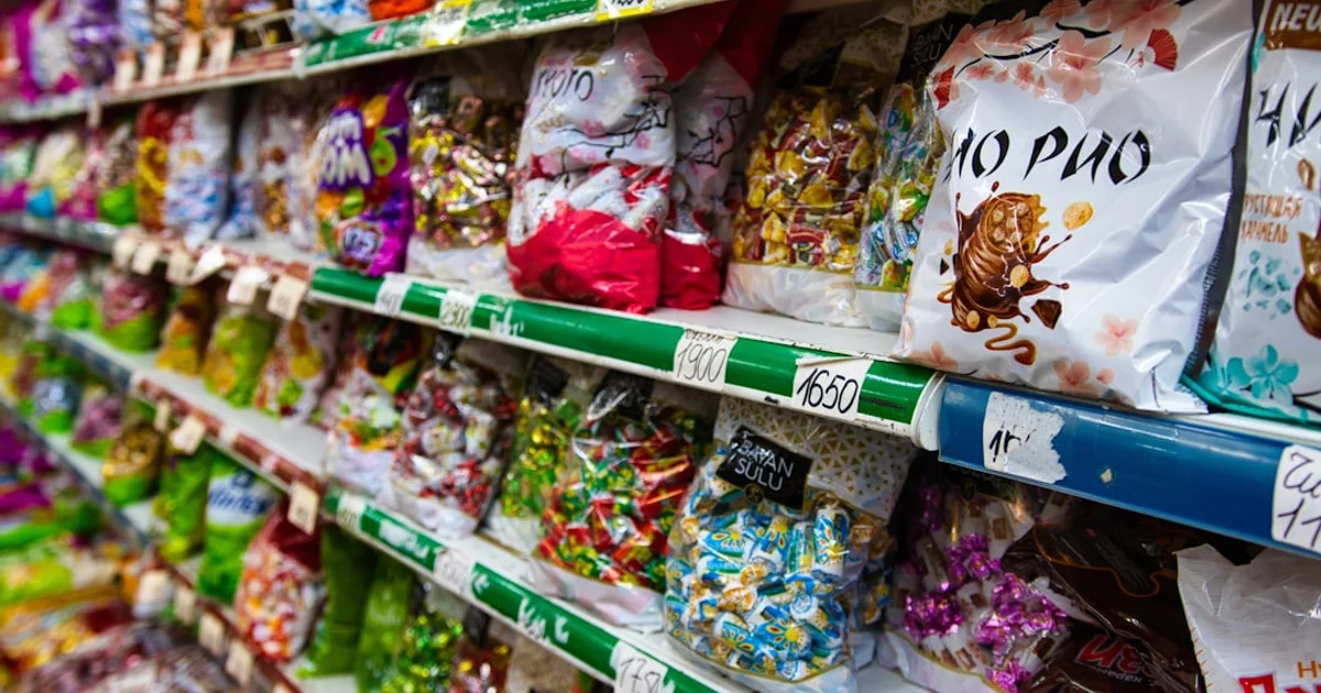 Discount store sweet aisle with tubs and bags of colourful sweets