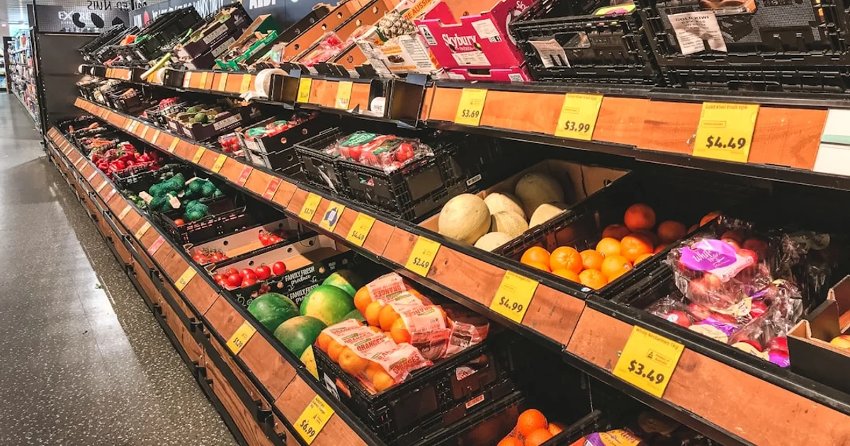 Fresh produce aisle with stocked shelves and price tags in a US supermarket