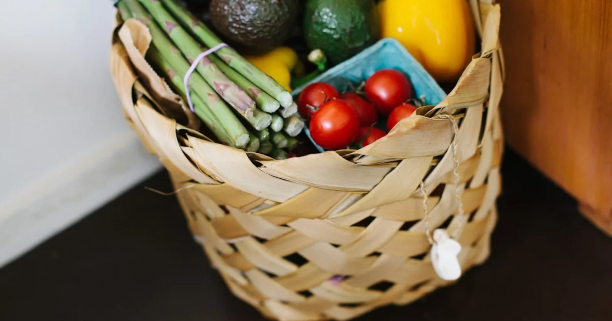 Online grocery delivery crates with fresh food arriving at a UK doorstep