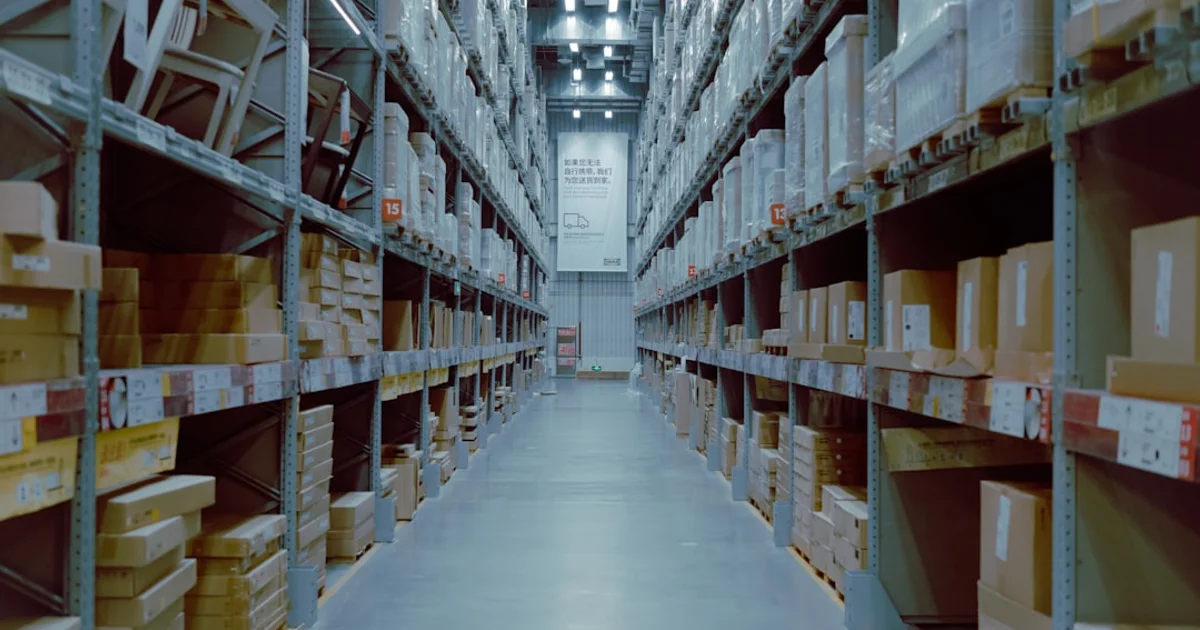 Tall warehouse club aisle with bulk boxes stacked on industrial shelving
