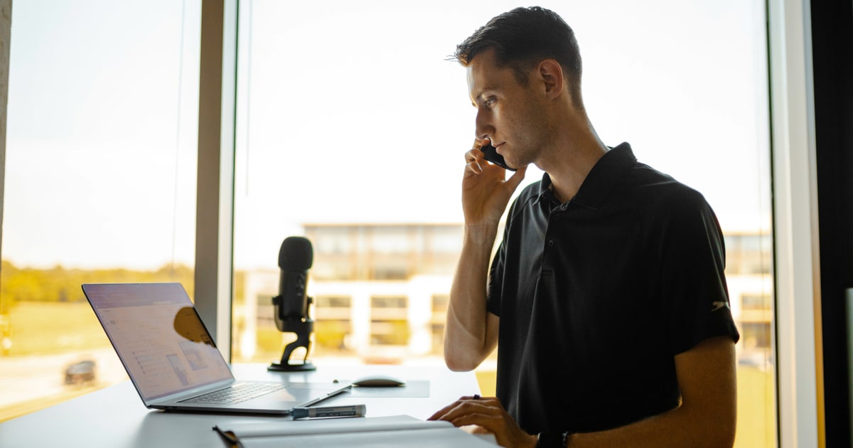 Person using voice commands on a phone — voice search lets you check E-codes hands-free in-store