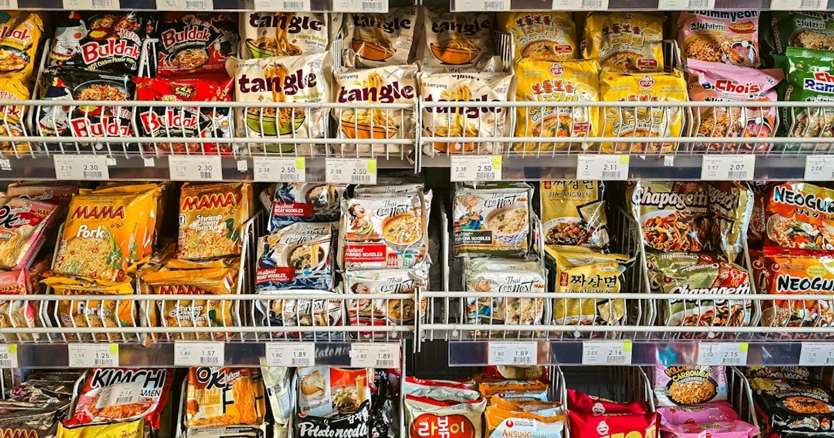 Indonesian packaged snacks and instant noodles on a shelf — the SJPH halal assurance system behind the Halal Indonesia logo