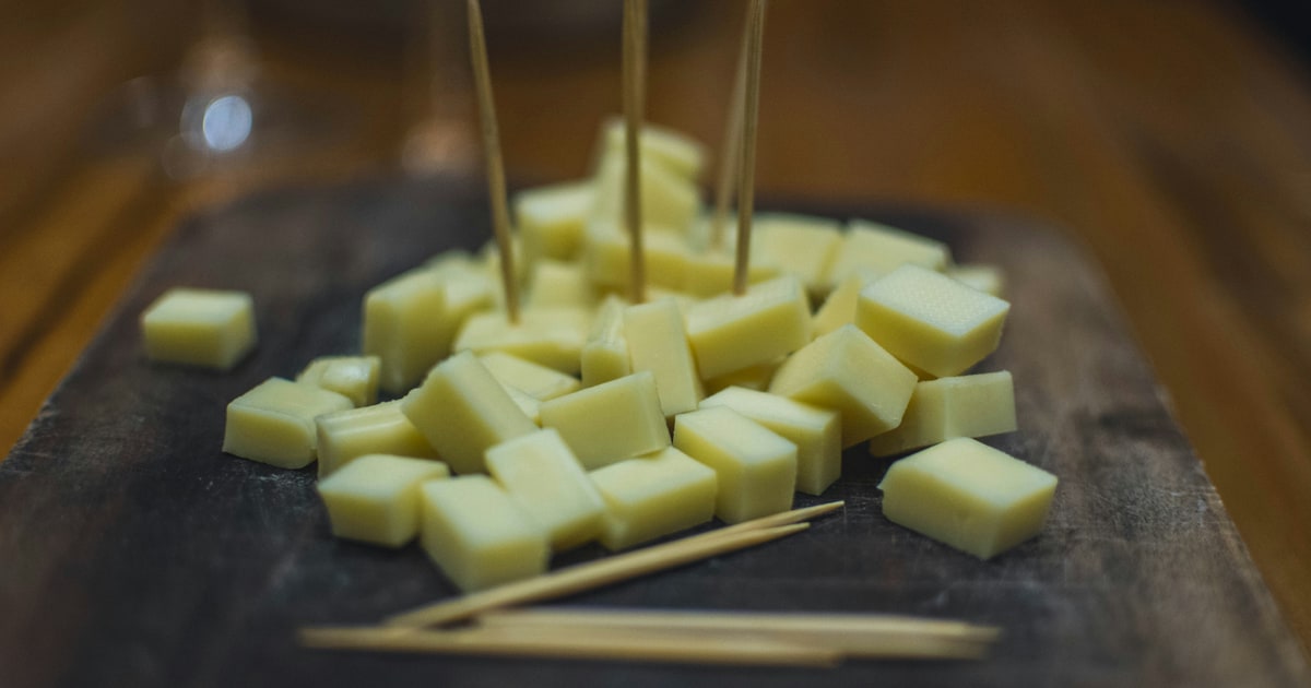 Cheddar cheese block with ingredient label showing rennet type