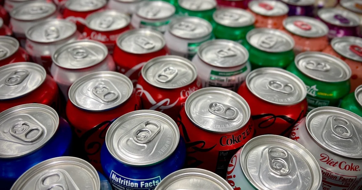 Diet soft drink cans and sugar-free packaging, representing products containing E951 aspartame