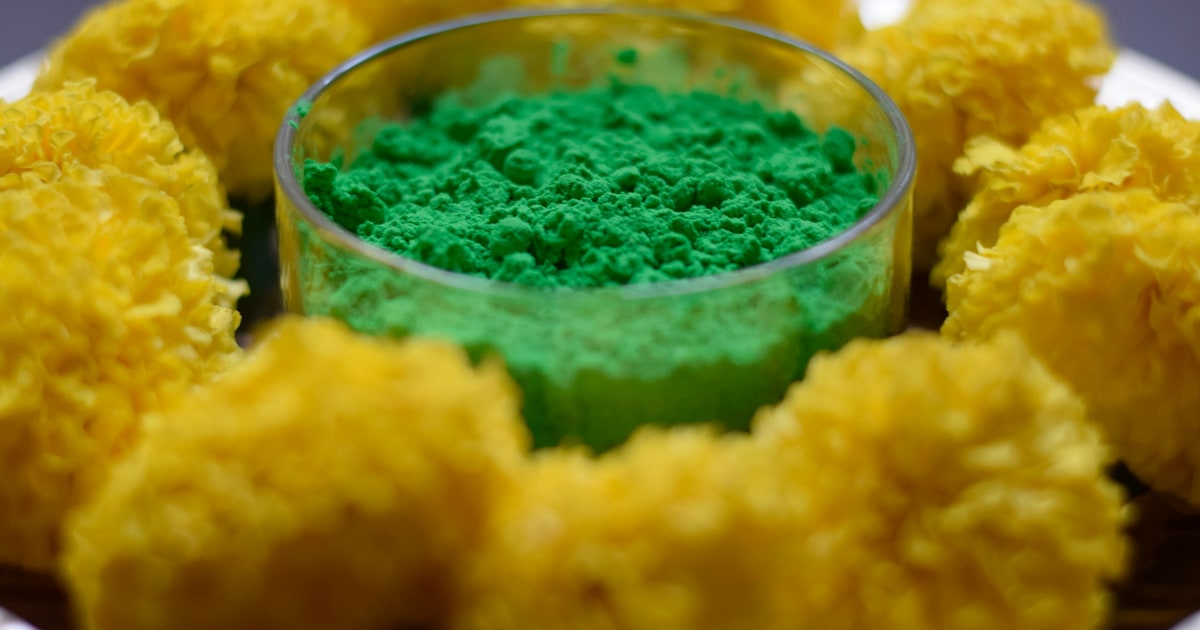 Array of brightly coloured food products and sweets on a table, each showing different food dye colours