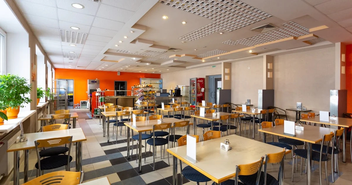 Food court dining hall with multiple stalls, representing Koufu food courts in Singapore