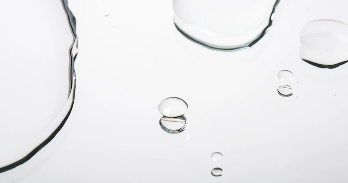 Clear liquid flavour extract in small glass bottles on a white surface, propylene glycol halal guide