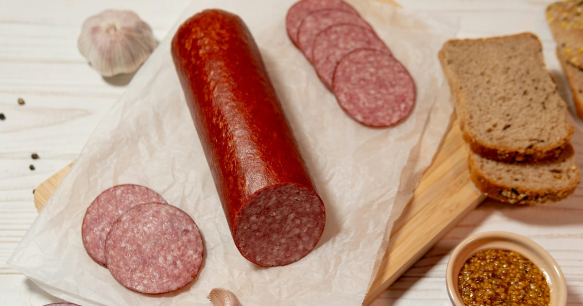 Sliced salami on a wooden board — is salami halal or haram?