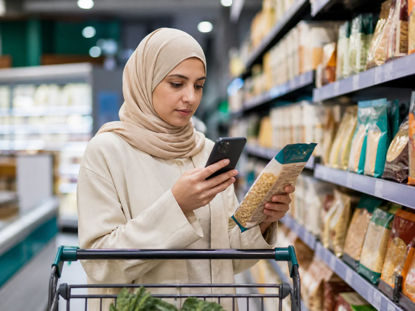 Halal-conscious shopper checking a food label with her phone